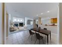 Open-concept living space with fireplace, dining area, and a view of the kitchen at 10924 Bandol Pl, Las Vegas, NV 89141