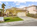 Lovely single-Gathering home boasts a manicured lawn, mature trees, and an attached two-car garage at 1184 Warm Canyon Way, Las Vegas, NV 89123