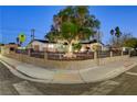 Corner lot featuring manicured lawn and desert landscaping with wrought iron fence and sidewalk at 1401 S 17Th St, Las Vegas, NV 89104