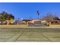 Street view of single story home with manicured yard, decorative rock, and decorative wrought iron fence at 1401 S 17Th St, Las Vegas, NV 89104