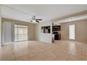 Open living room with tile floors, ceiling fan, and sliding doors to the patio at 1405 Vegas Valley Dr # 170, Las Vegas, NV 89169