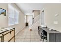 Bright living area with tile floors, staircase, and plenty of natural light at 1422 Ozzie Smith Ave, Henderson, NV 89074