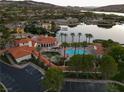 Community pool area with palm trees, lounge chairs, and well-maintained landscaping at 15 Via Mantova # 104, Henderson, NV 89011