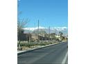 Street view with desert landscaping and mountain views offering an inviting neighborhood atmosphere at 1819 Wild Grain Ave, North Las Vegas, NV 89086