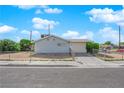 Cozy single-story home with a driveway, garage and chain link fence for security at 2012 Wendell Ave, Las Vegas, NV 89101