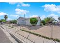 Modest home featuring a chain link fence, desert landscaping and mature landscaping at 2012 Wendell Ave, Las Vegas, NV 89101