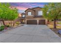 Charming two-story home with a well-maintained front yard and a spacious three-car garage at 231 Pioneers Peak Ave, Henderson, NV 89002