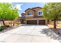 Charming two-story home with a well-manicured lawn, mature trees, and a spacious three-car garage at 231 Pioneers Peak Ave, Henderson, NV 89002