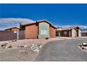 A view of the home's fenced yard, accented with decorative rock and desert landscaping at 2330 Deadwood St, Pahrump, NV 89048