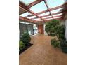 Enclosed patio with tiled flooring and mature landscaping at 3058 Conquista Ct, Las Vegas, NV 89121