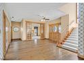 Elegant foyer with hardwood floors, staircase, wood trim and doors, and views to other rooms at 3111 Coachlight Cir, Las Vegas, NV 89117
