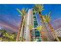 Striking view of a modern high rise building with lush landscaping and a colorful sky at 322 Karen Ave # 703, Las Vegas, NV 89109