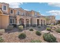 Townhome with desert landscaping, a covered entryway, and a tile roof at 3281 Pergusa Dr, Henderson, NV 89044
