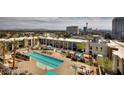 Stunning aerial view of a community pool surrounded by cabanas, lounge chairs, and well-maintained landscaping at 353 E Bonneville Ave # 369, Las Vegas, NV 89101