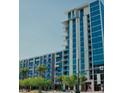 Modern high-rise building featuring sleek architecture and balconies with vibrant blue accents at 353 E Bonneville Ave # 369, Las Vegas, NV 89101