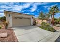 Nevada home featuring desert landscaping, a driveway, and two car garage with a neutral color scheme at 4177 Pacifico Ln, Las Vegas, NV 89135