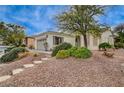 Inviting single-story home boasting desert landscaping, a two-car garage, and a cozy front entryway at 4177 Pacifico Ln, Las Vegas, NV 89135