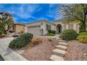 Charming single-story home with a two-car garage, desert landscaping, and a welcoming front entrance at 4177 Pacifico Ln, Las Vegas, NV 89135