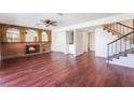 Inviting living room with brick fireplace, hardwood floors, and staircase leading to upper level at 4406 Flowerdale Ct, Las Vegas, NV 89103
