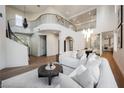 Spacious living room with high ceilings, a staircase, and contemporary furnishings at 501 Proud Eagle Ln, Las Vegas, NV 89144