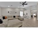 Bright living room boasts vaulted ceiling, ceiling fan, and wood-look floors at 5988 Turtle River Ave, Las Vegas, NV 89156
