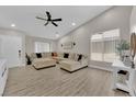 Spacious living room with vaulted ceiling, neutral paint, ceiling fan, and wood-look floors at 5988 Turtle River Ave, Las Vegas, NV 89156