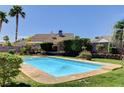 A sparkling backyard pool with mature landscaping, providing a relaxing oasis at 6513 Echo Crest Ave, Las Vegas, NV 89130