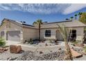 Inviting single-story home boasting desert landscaping, a three-car garage, and tiled roof at 6513 Echo Crest Ave, Las Vegas, NV 89130