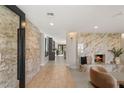 Elegant entryway with tile floors, brick accent wall, and a view of the living room at 6975 Darby Ave, Las Vegas, NV 89117