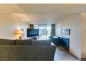 Inviting living room with a TV, comfy sofas, fireplace, and sliding glass doors to a patio at 730 S Royal Crest Cir # 426, Las Vegas, NV 89169