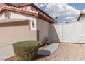 Exterior of home featuring a gated side yard, desert landscaping, and a two car garage at 7317 Bosky Springs St, Las Vegas, NV 89131