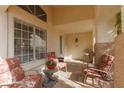 Cozy covered front patio with comfortable seating and a view of the surrounding landscape at 7317 Bosky Springs St, Las Vegas, NV 89131