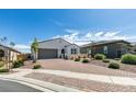 Inviting single-story home with brick-paved driveway and well-maintained landscaping at 792 Drammatico Pl, Henderson, NV 89011