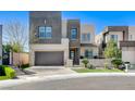 Stunning modern two-story home featuring a two-car garage and manicured front yard at 795 Glistening Light Ct, Henderson, NV 89052