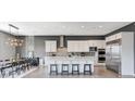 Bright kitchen featuring stainless steel appliances, a large island, and adjacent dining area at 795 Glistening Light Ct, Henderson, NV 89052