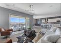 Open concept living room featuring mountain views, modern decor, and tile flooring at 795 Glistening Light Ct, Henderson, NV 89052