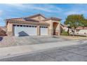 Attractive single-story home featuring a three-car garage and low-maintenance front yard at 1036 Kennebunk Cir, Henderson, NV 89015