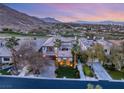 Breathtaking aerial view showcasing the property's prime location with mountain views and a lush golf course at 11680 Evergreen Creek Ln, Las Vegas, NV 89135