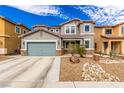 Charming two-story home with a grey exterior, stone accents, a blue-grey garage door, and low-maintenance desert landscaping at 140 Rolling Cove Ave, Henderson, NV 89011