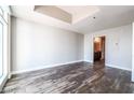 Bright bedroom with hardwood floors, featuring a ceiling tray and ensuite bathroom at 150 N Las Vegas Blvd # 804, Las Vegas, NV 89101