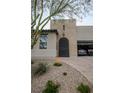 Inviting home exterior with an arched front door, desert landscaping, and a brick-paved driveway at 1608 Rock Ridge Pl, North Las Vegas, NV 89084