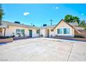 Expansive front yard featuring desert landscaping, a brick planter, and ample parking space at 1700 Ivanhoe Way, Las Vegas, NV 89102