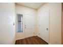 Inviting entryway with a wood-look floor, window, and a white front door at 1859 Cypress Greens Ave, Henderson, NV 89012