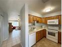 Bright kitchen featuring wood cabinets and white appliances at 2072 Mesquite Ln # 102, Laughlin, NV 89029