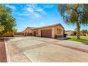 Large driveway with a three-car garage, providing ample parking space and leading to the home's entrance at 215 Great Gable Dr, Las Vegas, NV 89183