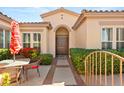 Inviting front entrance with a double door, featuring well-maintained landscaping and a cozy outdoor seating area at 215 Great Gable Dr, Las Vegas, NV 89183