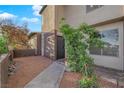 Inviting townhouse entrance with desert landscaping, featuring a modern front door and neutral color scheme at 241 E Van Wagenen St, Henderson, NV 89015