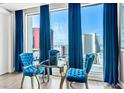 Chic sitting area with blue velvet chairs and a lovely view of the Las Vegas skyline at 2700 Las Vegas Blvd # 1401, Las Vegas, NV 89109