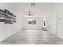 Bright and open living room with gray-tone wood flooring and a ceiling fan at 2915 Cedar Ave # 12C, Las Vegas, NV 89101