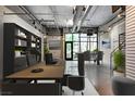 Functional office with modern furnishings, including a spacious desk and comfortable seating, next to meeting space at 353 E Bonneville Ave # 183/283, Las Vegas, NV 89101